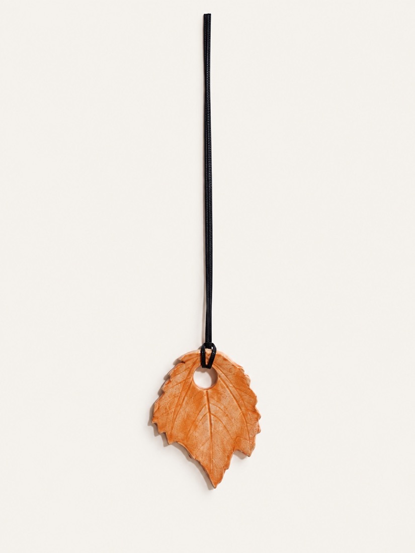 Collar de cordón negro con un colgante de cerámica en forma de hoja naranja